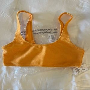 Kylie Jenner orange shimmer swimsuit.